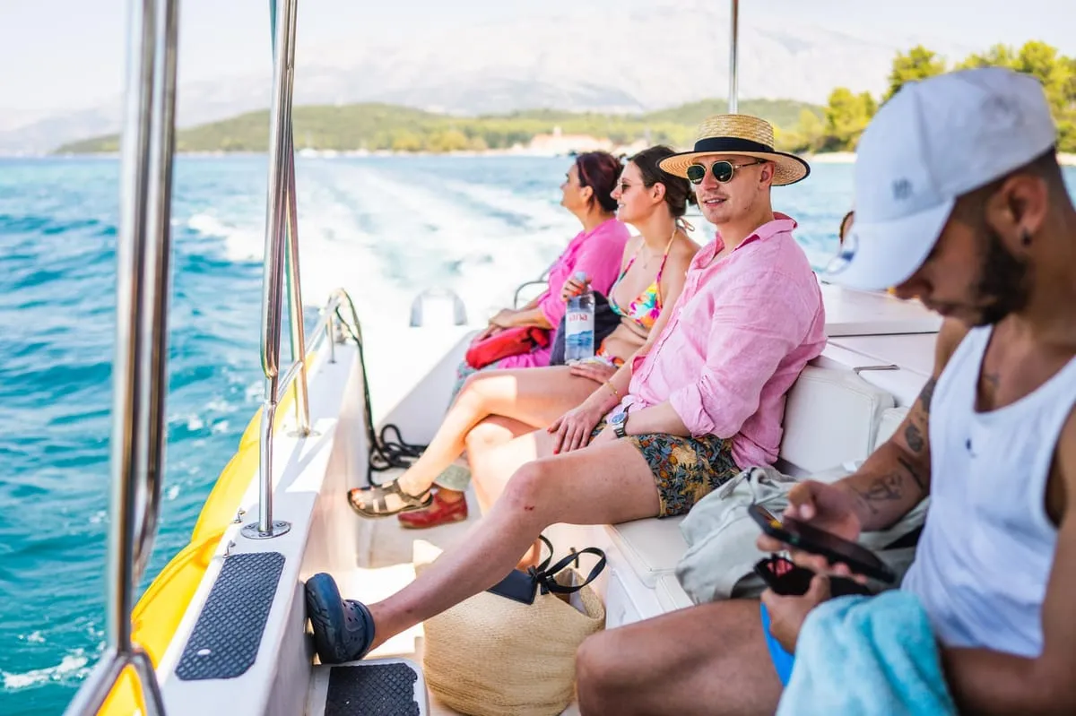 Yellow catamaran moored at a turquoise lagoon in the Korcula archipelago on the three island catamaran tour to Badija Vrnik and Stupe in Croatia