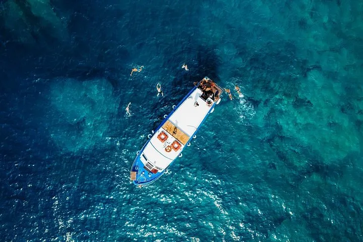 Traditional wooden Dalmatian boat under way between green islands on the Korcula Boat Adventure Tour in Croatia